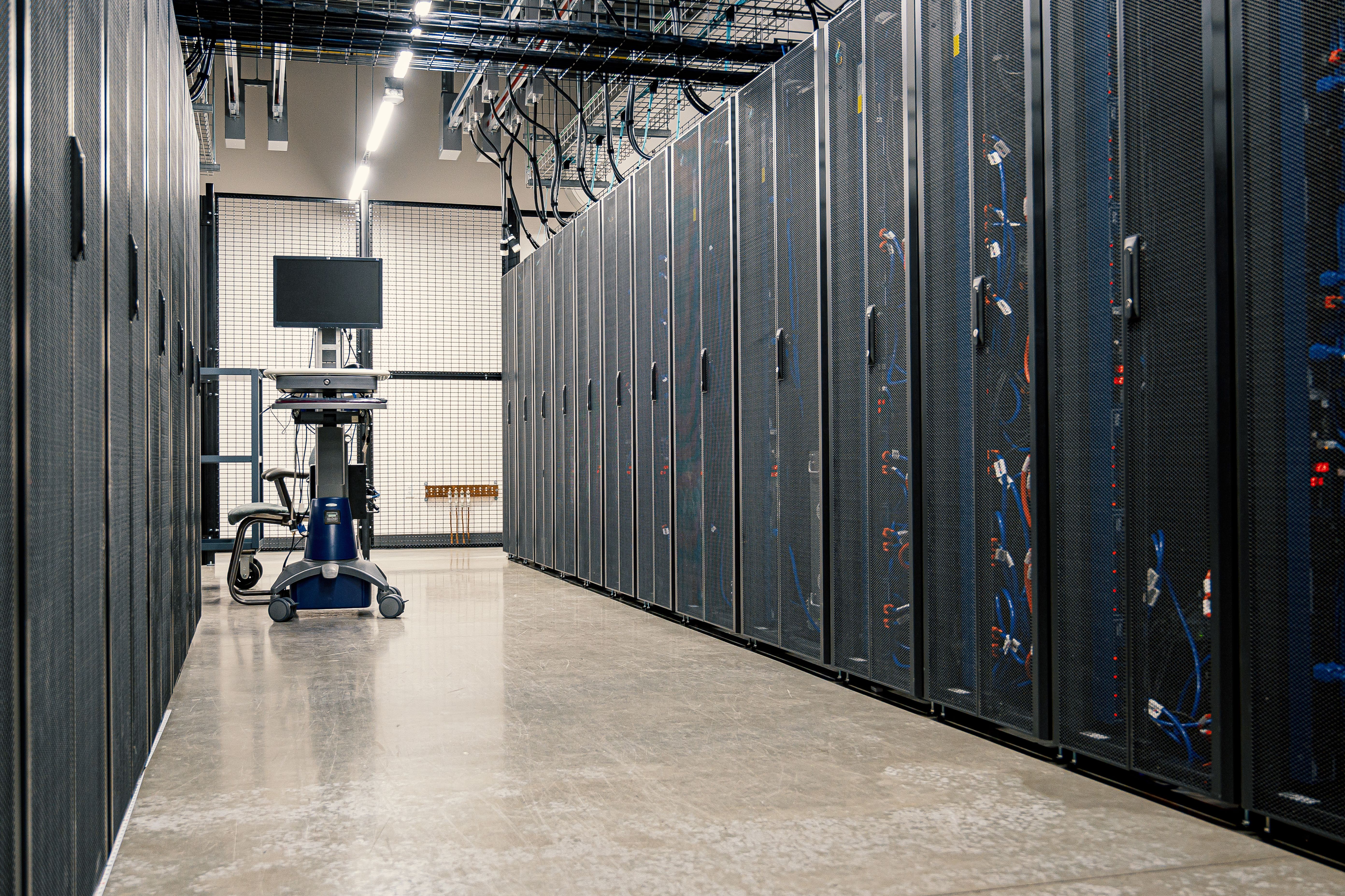 Server racks in an active data hall, cabling routed overhead